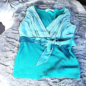 T-shirt.  Fancy.  Turquoise.  Size M.  Runs small.  Bought overseas.